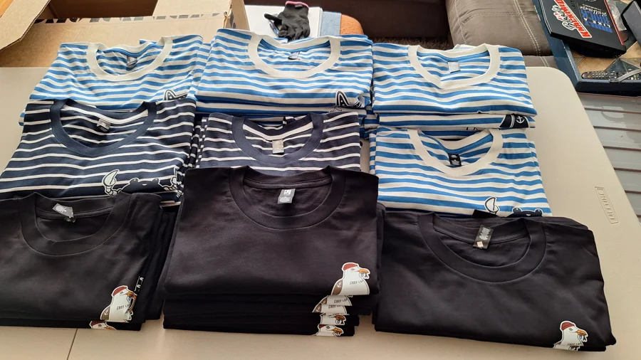 Finished printed shirts arranged in a coordinated apparel order at Backhat
