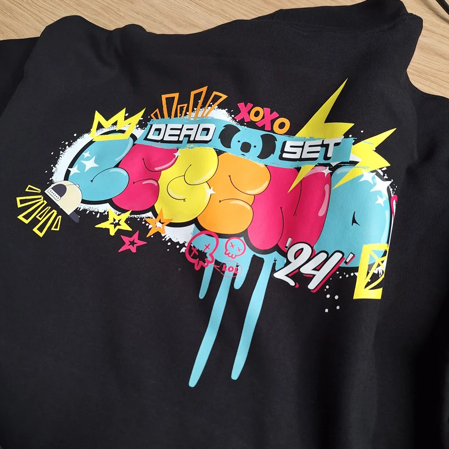 Colourful Deadset Legend graphic printed on a black T-shirt