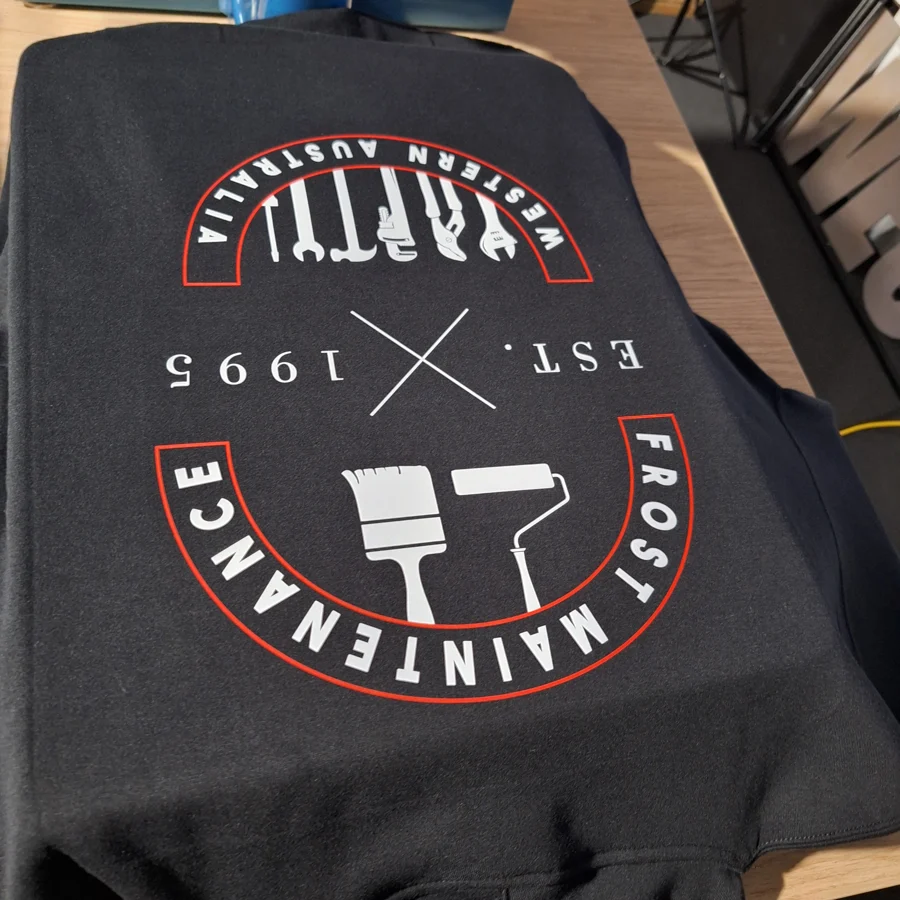 Frost Maintenance circular logo printed on dark workwear