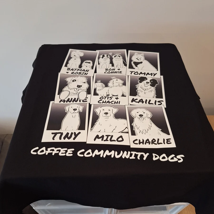 The Grind Reaper café T-shirt with a printed grid of illustrated dogs